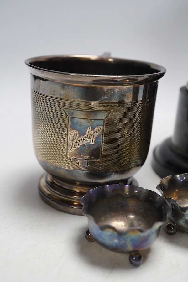 A George V silver trophy cup and cover, an Art Deco silver sugar shaker, a similar engine turned silver christening cup, and six silver salt cellars (9). Condition - fair